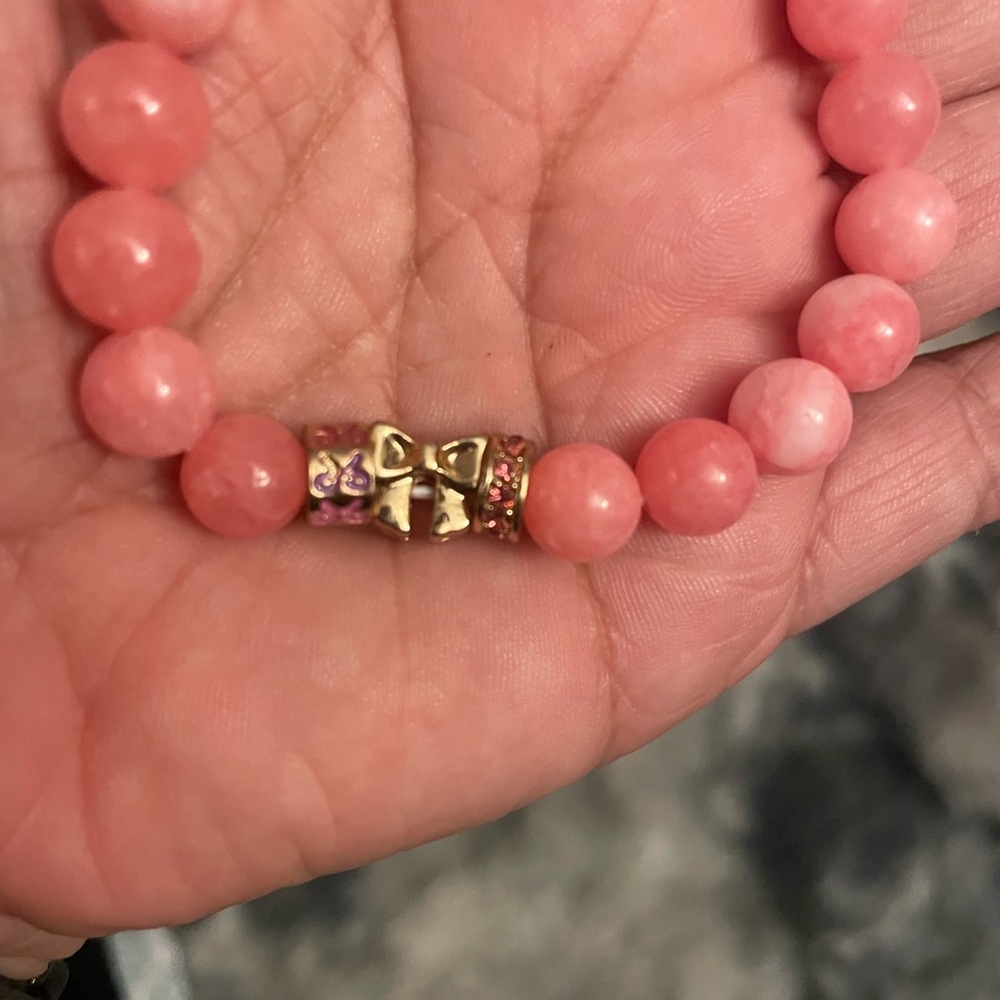 Elegant Pink Beaded Bracelet with Gold Bow Accents